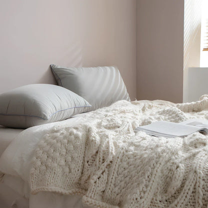 Beige hand-woven acrylic wool blanket 120x150cm 1.7kg on sofa, low 2-3% shrinkage