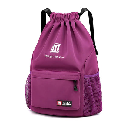 Large bucket-shaped travel backpack in blue with drawstring closure and soft black shoulder straps.
