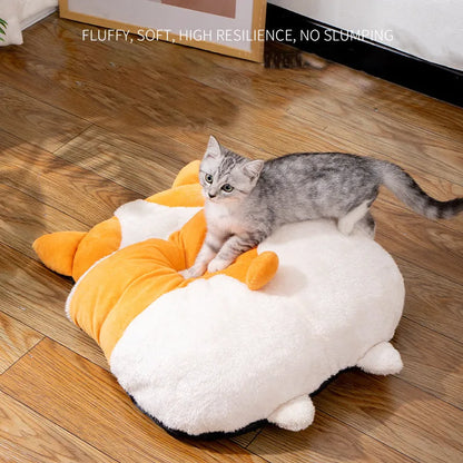 Orange semi-closed sleeping bag bed for cats on a floor, showing soft interior and dimensions.
