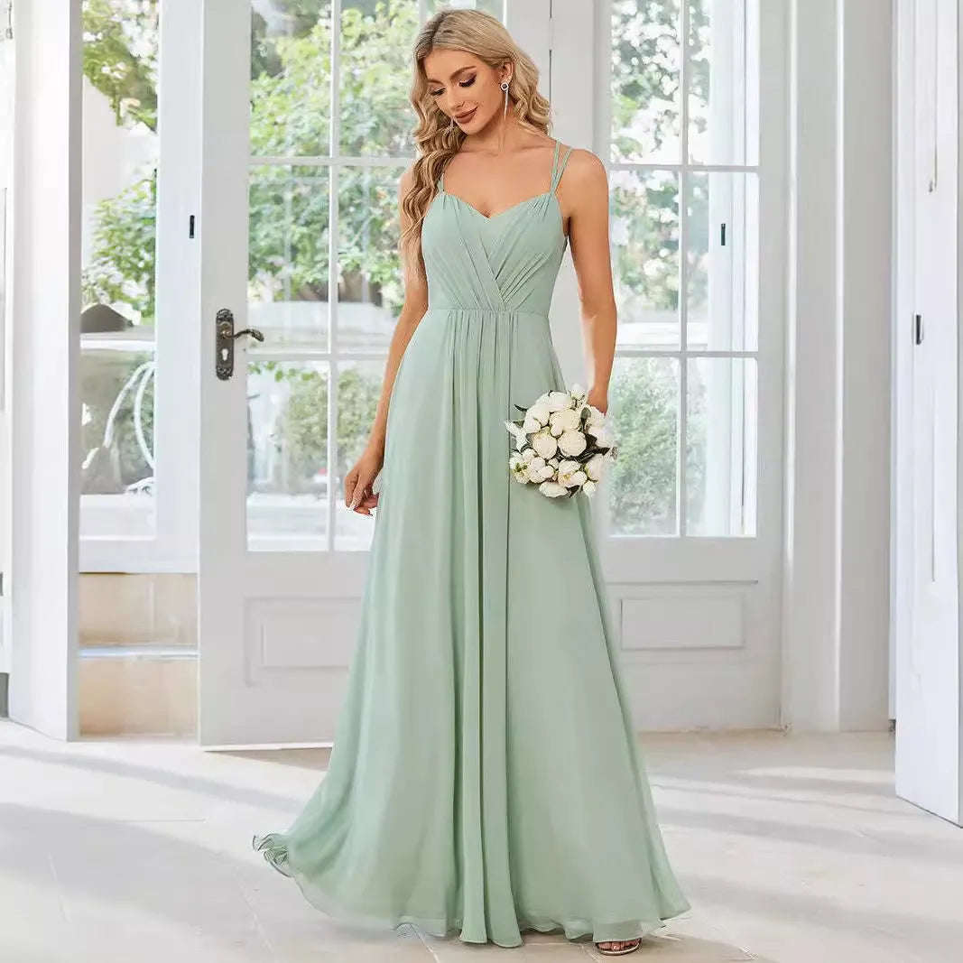 Women's sleeveless long dress with sling neckline and pleated A-line skirt in a solid colour.