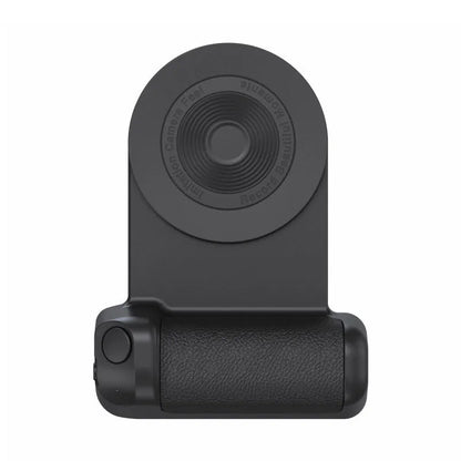 Black magnetic phone camera grip holder with rotatable stand on a table next to a smartphone.