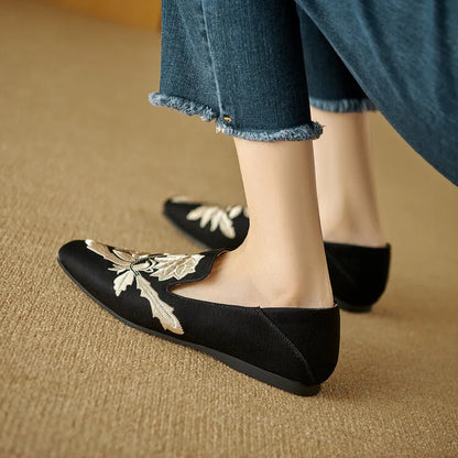 Women's black embroidery retro flat pumps with round toe and shallow-mouth design on a soft sole.