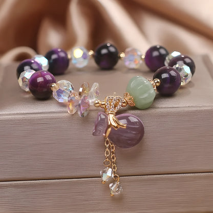 Women's forest style crystal bracelet with purple tigereye money bag pendant and rhinestone details