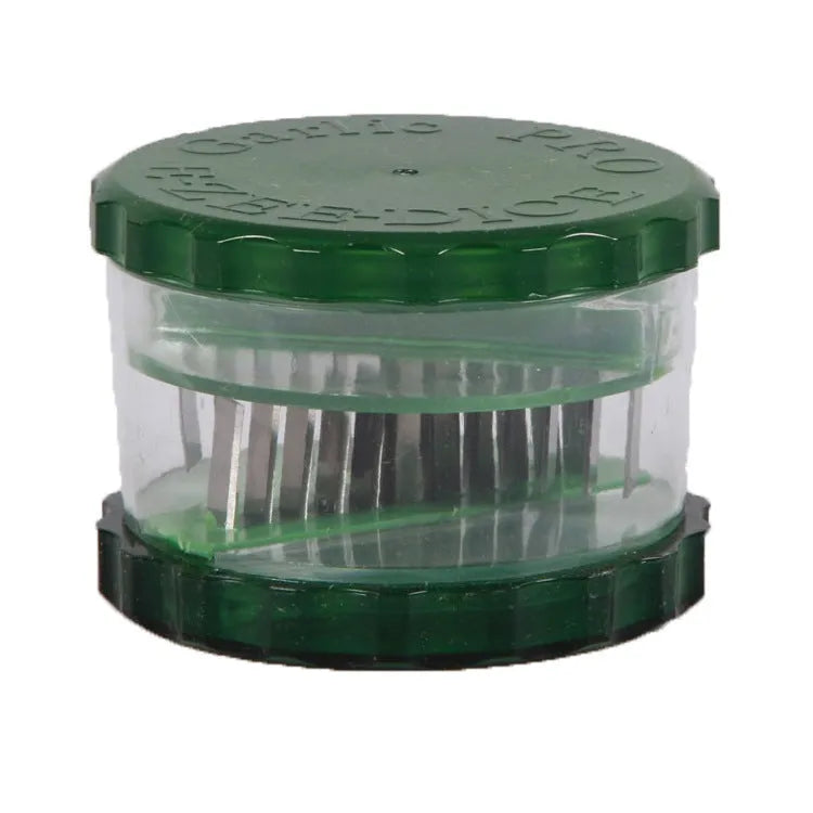 Green manual garlic peeler kitchen tool with silicone roller and plastic press handle.