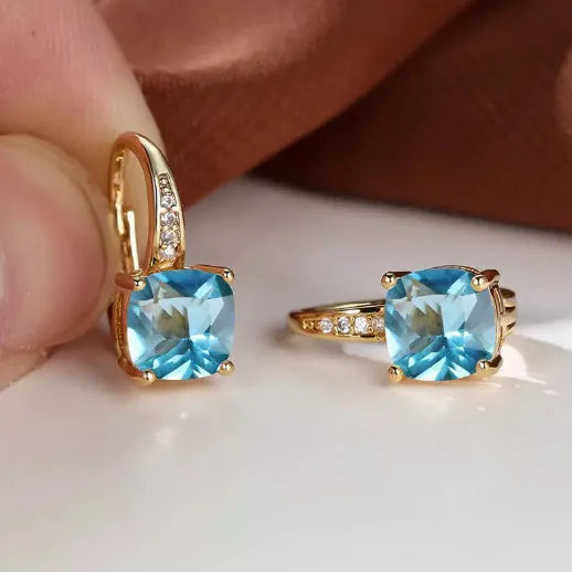 Square geometric ear clips with colourful moissanite inlays and a metallic electroplated finish.