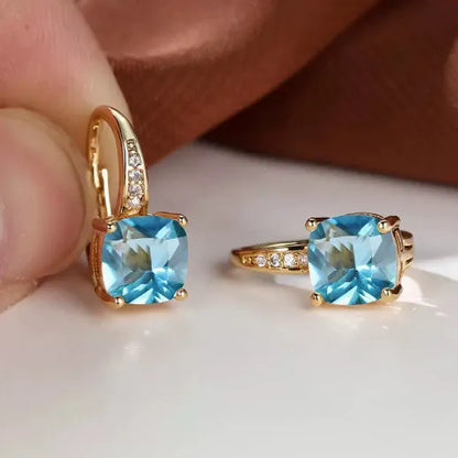 Square geometric ear clips with colourful moissanite inlays and a metallic electroplated finish.
