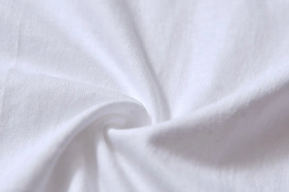 White cotton pullover overalls with a pattern, short sleeves, and a round neck on a teenager.
