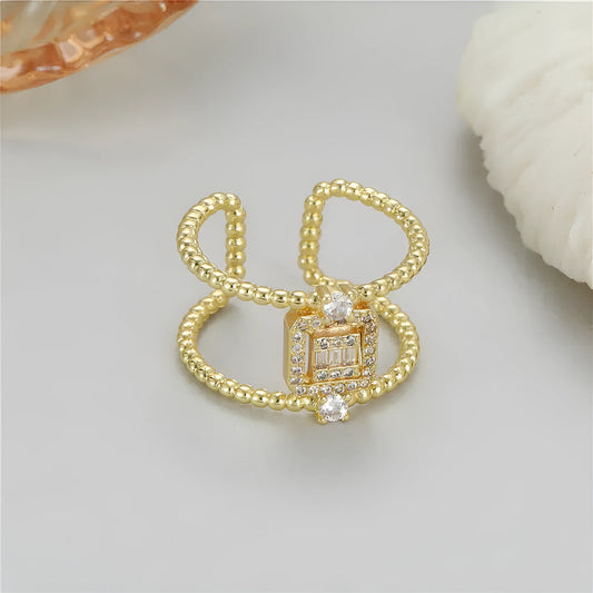 Adjustable open ring with asymmetric U-shaped design in 14K gold-plated copper, showing opening mechanism
