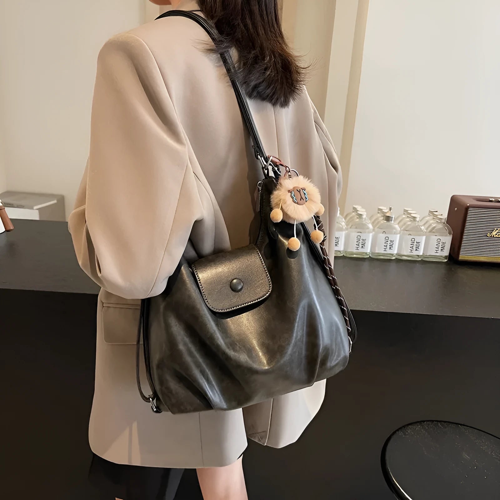 Textured PU leather women's shoulder bag in black with single strap and optional pendant