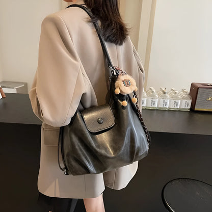 Textured PU leather women's shoulder bag in black with single strap and optional pendant