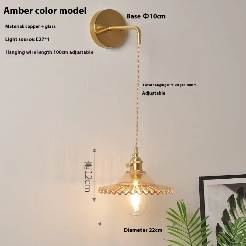 Retro brass lotus wall lamp with copper body and glass shade in various colours, mounted on a wall