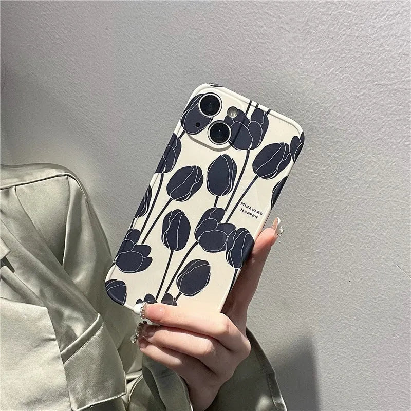 Cold Wind black silicone iPhone case with a white tulip floral pattern on the back.