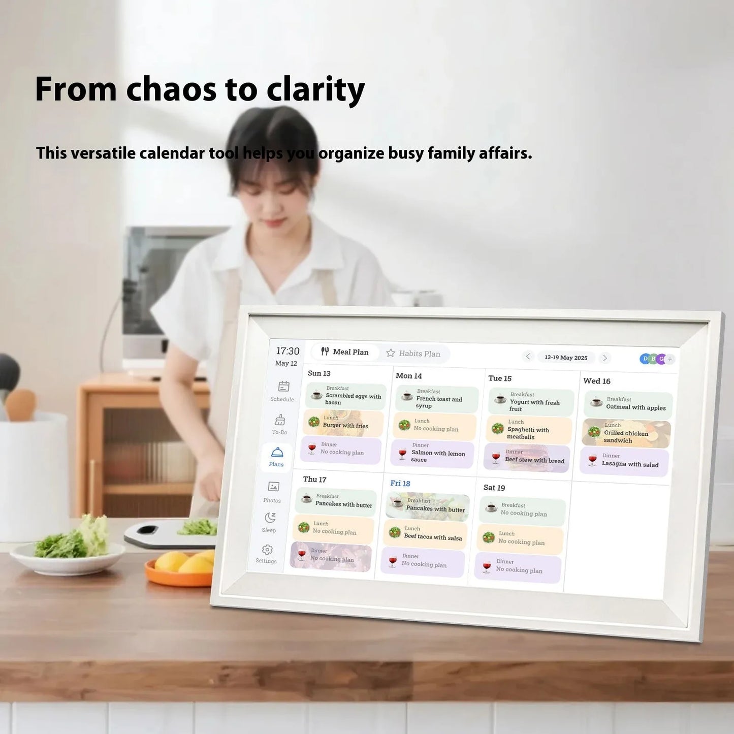 White smart digital photo frame with 15.6-inch screen on a table, showing a family photo in high definition.