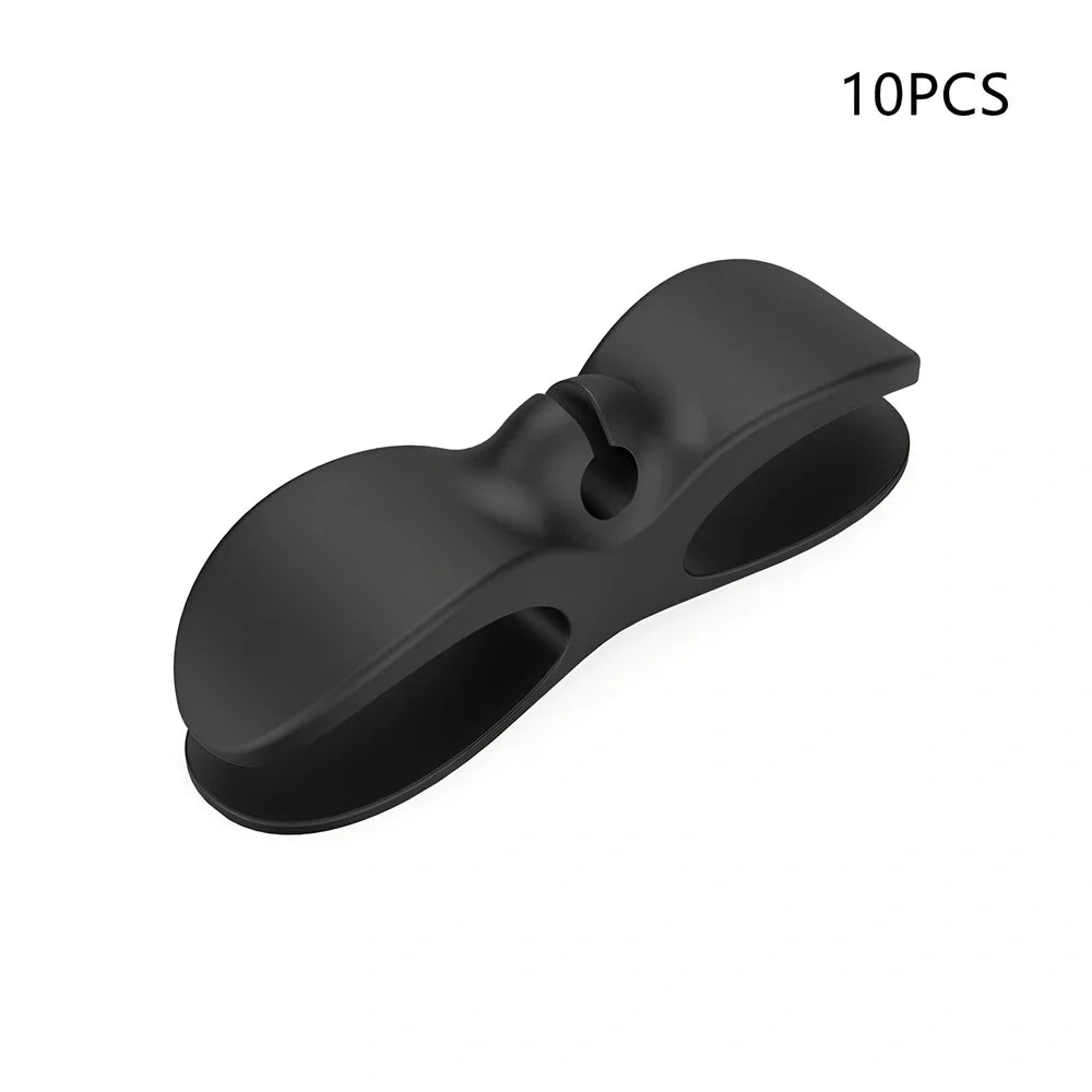 Black TPU cable organizer clips winding appliance cords on kitchen counter, 5cm size, non-marking adhesive for tidy management