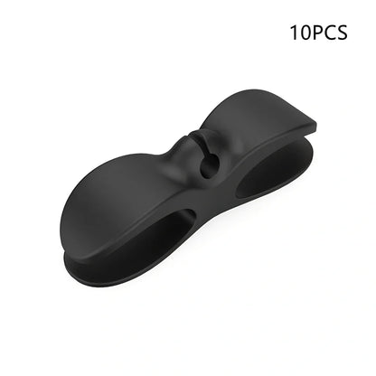 Black TPU cable organizer clips winding appliance cords on kitchen counter, 5cm size, non-marking adhesive for tidy management