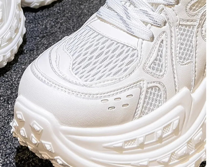 Women's white height increasing shoes with lace-up design and round toe, showing internal insole construction