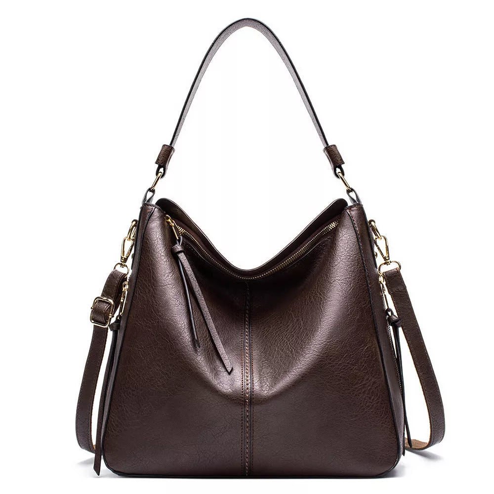 Women's hobo bag in PU material with multiple compartments and a zipper opening