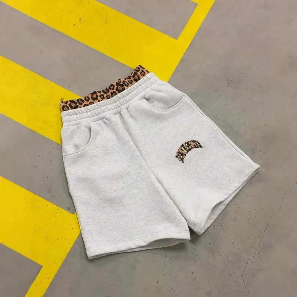 Men's patchwork double waist loose trousers with elastic polyester fabric for sports, showing zip placket closure and loose leg fit