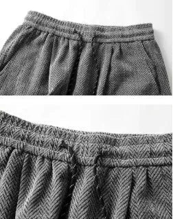 Light grey fleece-lined straight-leg trousers with hollow-out detail and elastic waistband on a hanger.