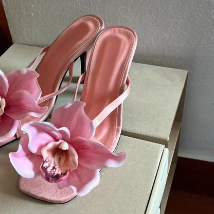 Pink women's flip-flop sandals with artificial Phalaenopsis orchid flower and square-toe design