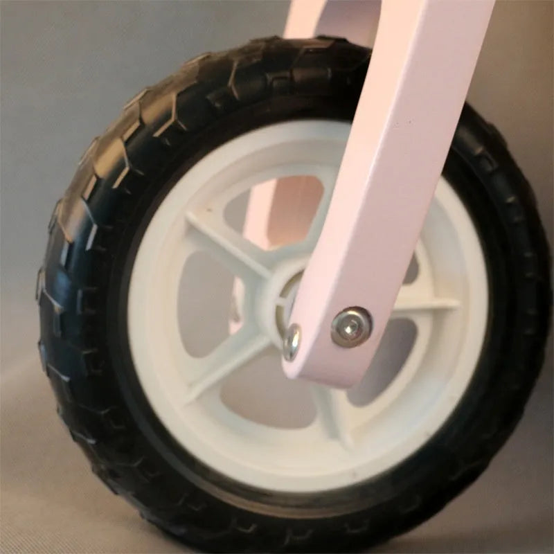Pink wooden balance scooter for toddlers measuring 10 inches, designed for children aged 1-6 years