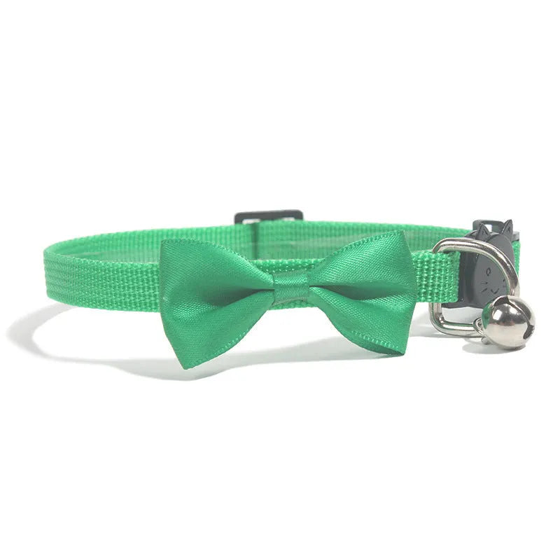Striped nylon cat collar with decorative bow and bell in multiple colour options on a white background.