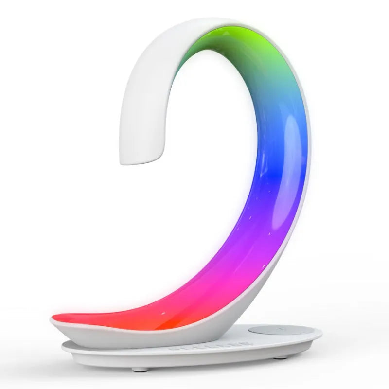 White swan-shaped desktop device with wireless charging surface, Bluetooth speaker, and colourful LED lighting effects
