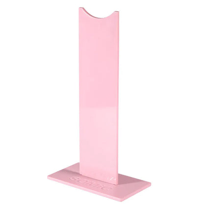 Pink detachable head-mounted gaming headset stand with non-slip silicone base on a desk
