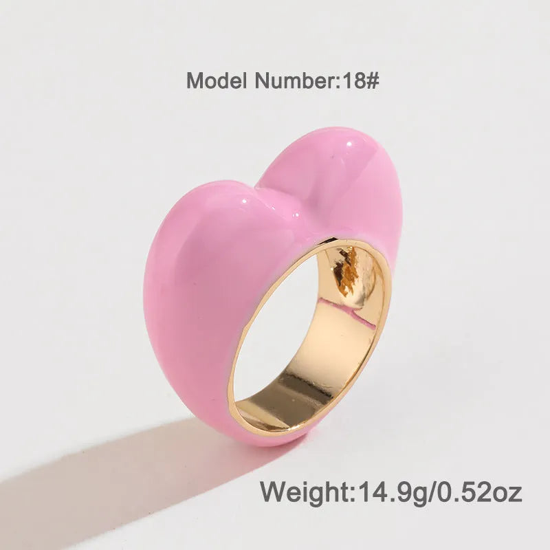 Heart-shaped enamel ring with three-dimensional detail in black, pink, purple, or red, sized for fingers 17-18