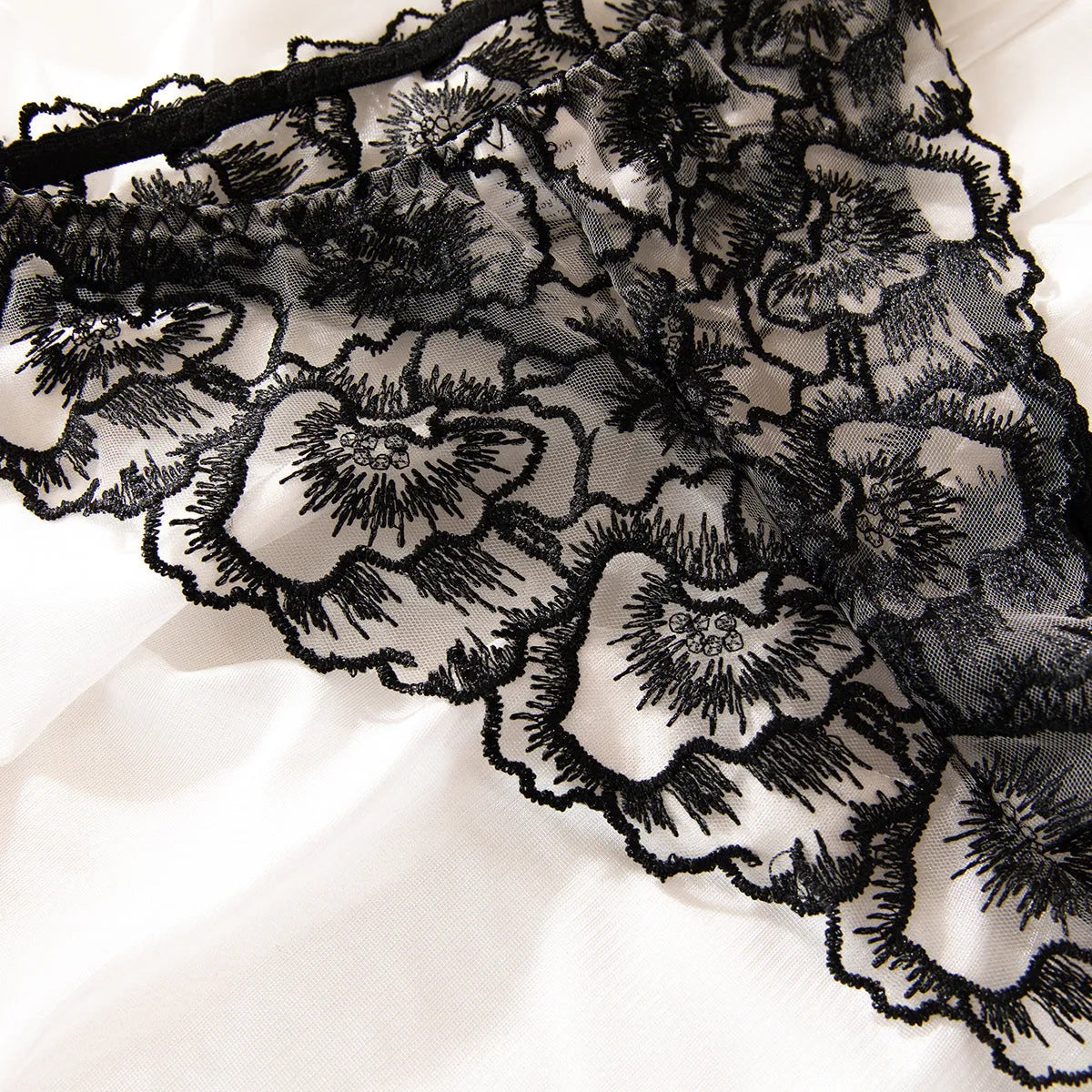 Black women's embroidered lace lingerie bikini with transparent sections and steel ring accents