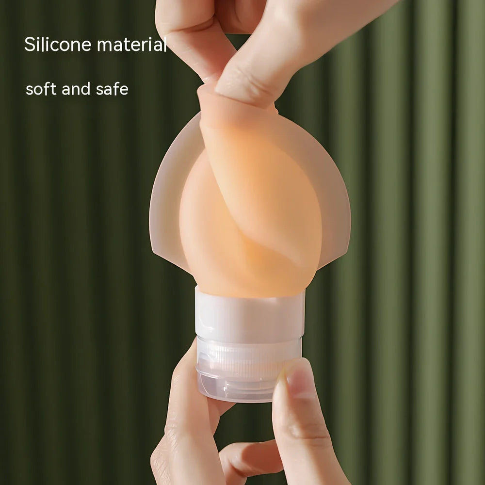 Three silicone travel bottles in different colours with stickers, showing 60ml and 90ml sizes for shampoo and cosmetics