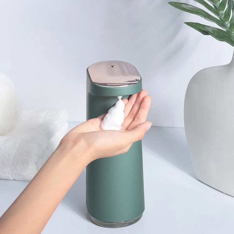White automatic foam soap dispenser with infrared sensor on a bathroom countertop.