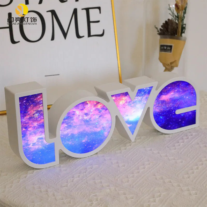 Rainbow halo LED love light with 'LOVE' word decoration on plastic casing.
