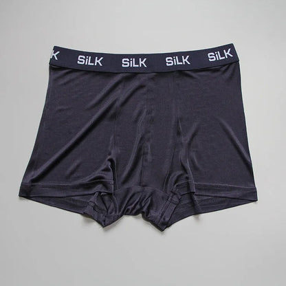 Men's loose-fitting silk shorts in navy blue on a neutral background.