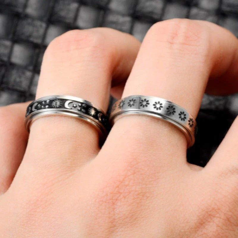 Stainless steel spinner ring with intricate moon and stars design
