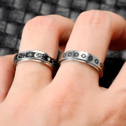 Stainless steel spinner ring with intricate moon and stars design