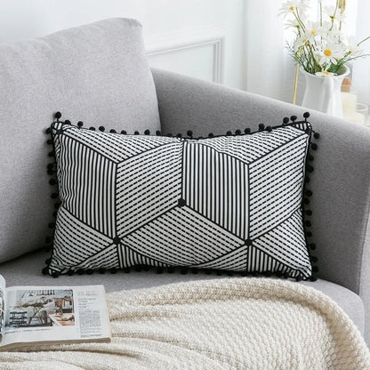 Bohemian style decorative pillowcase in light grey colour on a sofa.