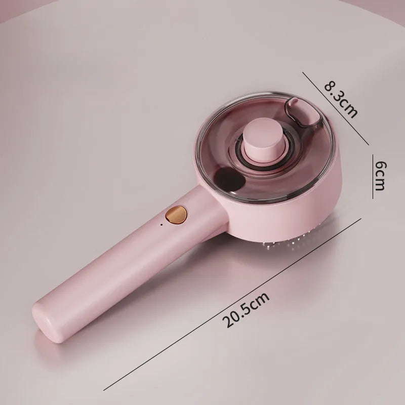 Pink and white cat steam brush with mist spray function, rounded head, and stainless steel comb bristles.