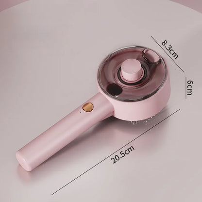 Pink and white cat steam brush with mist spray function, rounded head, and stainless steel comb bristles.