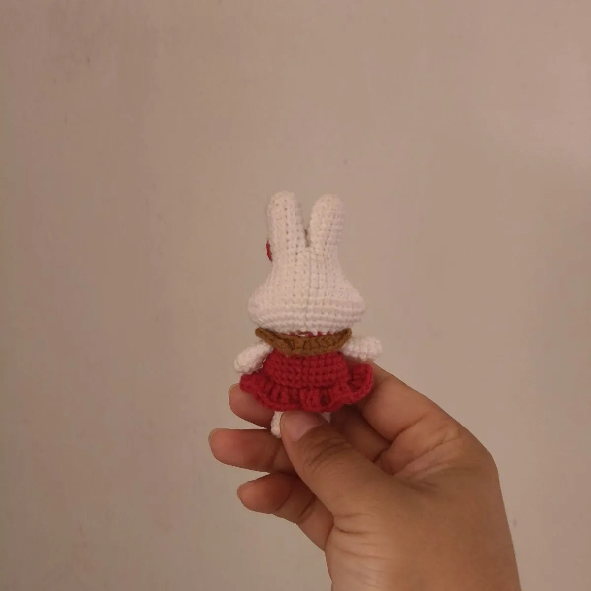 Hand-crocheted wool yarn rabbit keychain pendant with decorative design