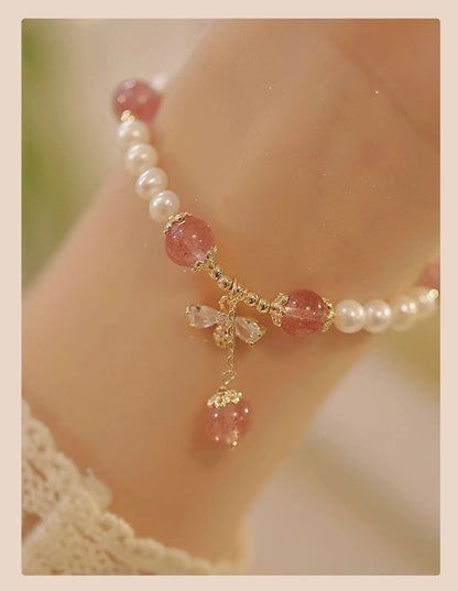 Women's adjustable Strawberry Quartz crystal bracelet with bow charm on wrist