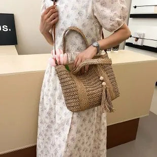 Women's large capacity straw crossbody bag in milky white or khaki with soft woven body and shoulder strap