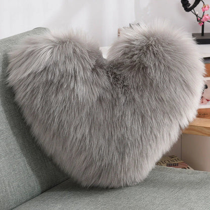 Cozy heart-shaped plush throw pillows in various colors and sizes for living room and bedroom decor