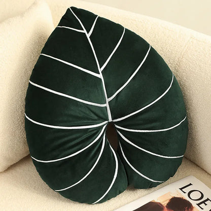 Green embroidered plant cushion with monstera leaf pattern on plush fabric