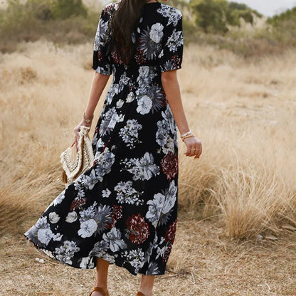 Yellow floral print women's dress with V-neck, short sleeves, elastic waist, and a large hemline midi skirt.