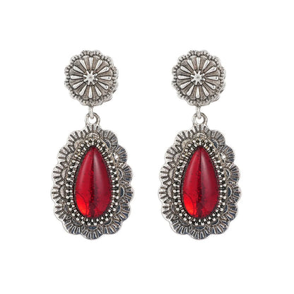 Pair of retro Bohemian carved drop earrings in red alloy for women, shown as a single pair
