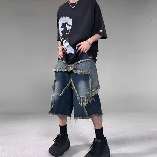 Blue men's loose-fit denim shorts with a frayed hem and a white five-pointed star patch on the leg.