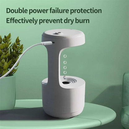 White columnar anti-gravity humidifier with LED clock display on a wooden desk