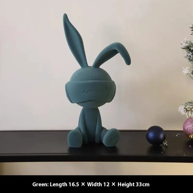 Green suede blindfold rabbit resin table ornament on a wooden shelf, showing detailed texture and 12cm height