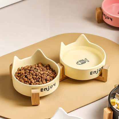 Porcelain cat bowl with anti-tumble wooden frame in pink with a cat paw design